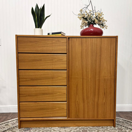 Tall teak dresser with five drawers on one side and cabinet on the other side.