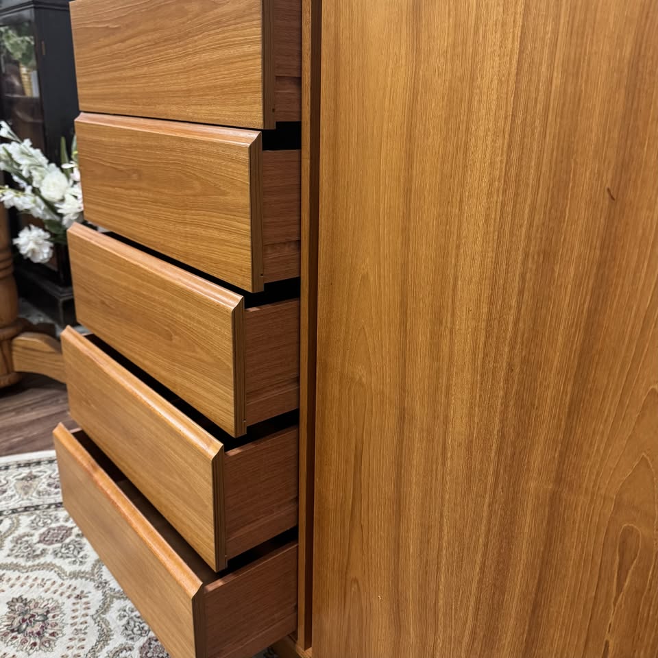 Close up view of open drawers of Danish MCM teak dresser and cabinet