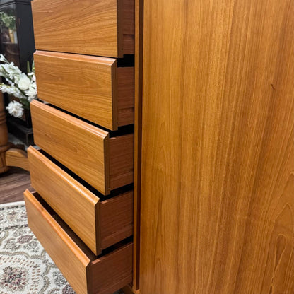 Close up view of open drawers of Danish MCM teak dresser and cabinet