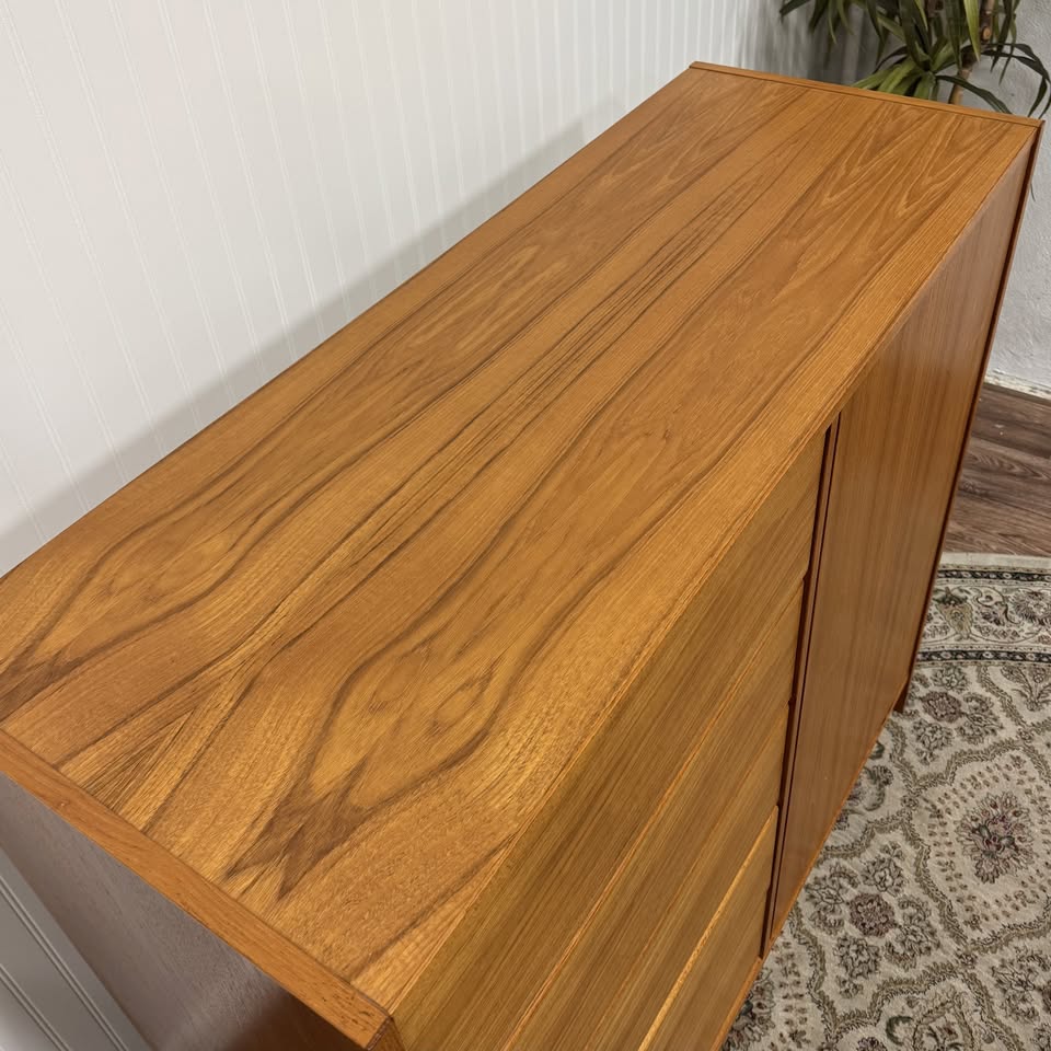 Close up view of the top of a Danish teak MCM dresser and cabinet, showing grain pattern