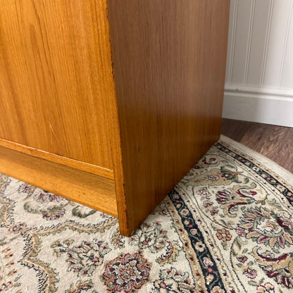 Close up view of right outside bottom edge Danish teak MCM dresser and cabinet
